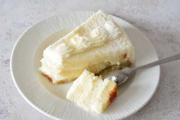 istock a slice of creamy cake with a fork on a plate 2166878432