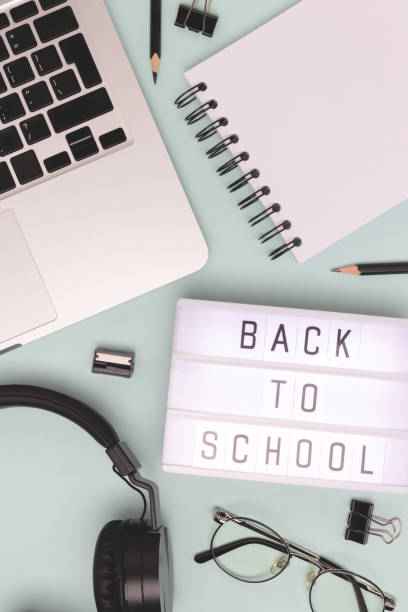 istock Back to school. Workspace with lightbox, laptop and office supplies on a blue background. 2166878620