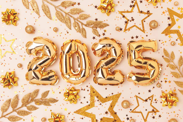 istock 2025 New Year composition. Golden balloons and decorations. 2166878665
