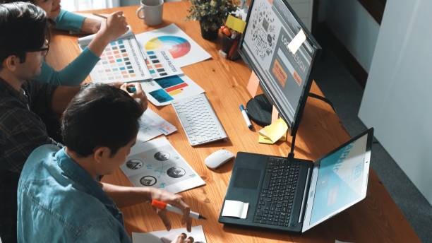 istock Smart designer helping manager choosing color from color palettes. Symposium. 2166879334