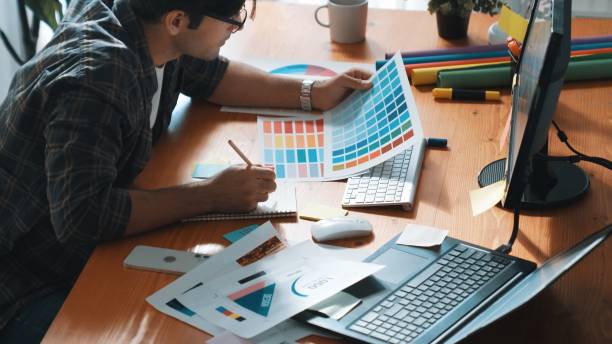 istock Designer look at screen and design color while looking at palette. Symposium. 2166880501