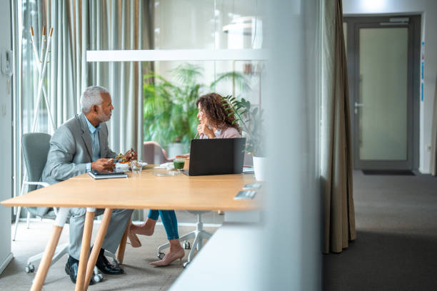 istock Diverse Business Colleagues Sharing Meal in Office 2166882970