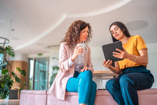 istock Diverse Female Colleagues Collaborate in Modern Office Setting 2166883772