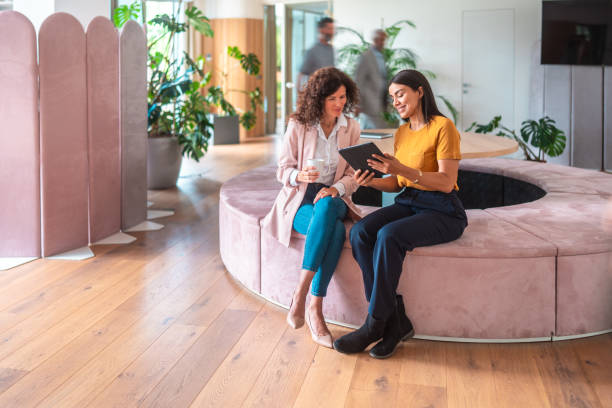 istock Caucasian and Hispanic Female Colleagues Collaborating in Modern Office 2166883779