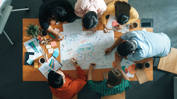 istock Group of business people writing and making mind map at meeting. Convocation. 2166884477