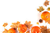Autumn leaves and pumpkins flat lay on white background