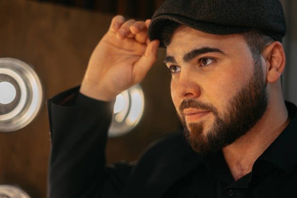 serious stylish attractive young man with a beard wearing formal clothes