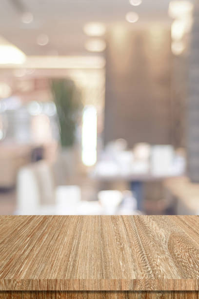 istock Table and blur restaurant background, Wooden counter cafe over blur bokeh light background, Shelf for food and retail shop, store food and product display backdrop, banner, mockup, vertical 2166888283