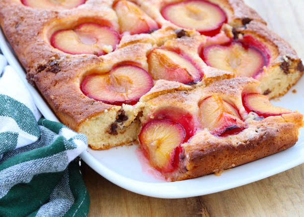 Plum tray cake with coconut and chocolate, sliced