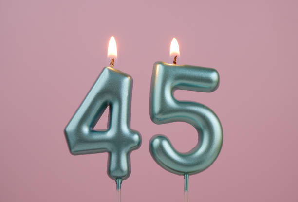 Blue birthday candles on pink background, number 45