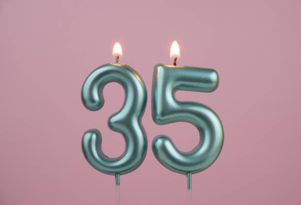 istock Blue birthday candles on pinky background, number 35 2166889190