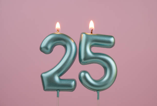 istock Blue birthday candles on pink background, number 25 2166889195