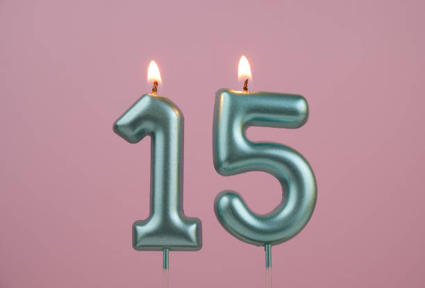 istock Blue birthday candles on pinky background, number 15 2166889199