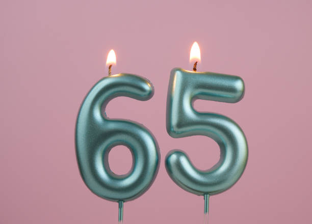 istock Blue birthday candles on pink background, number 65 2166889202