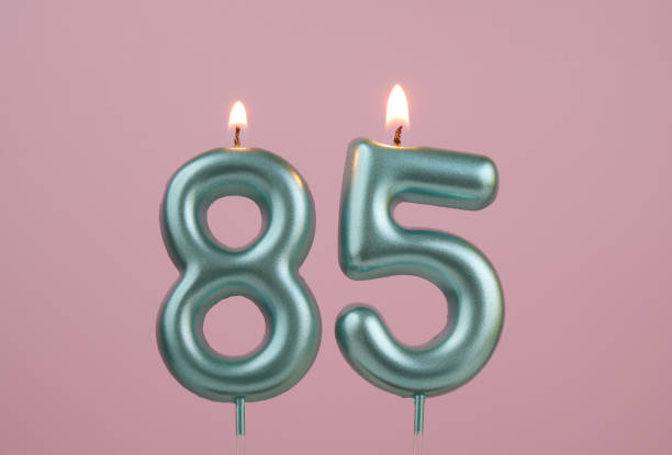 istock Blue birthday candles on pink background, number 85 2166889217
