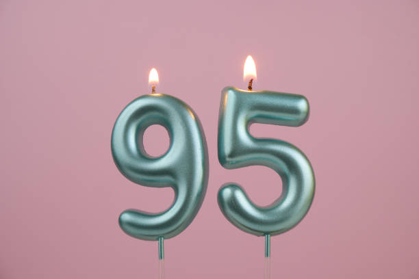 istock Blue birthday candles on pink background, number 95 2166889219