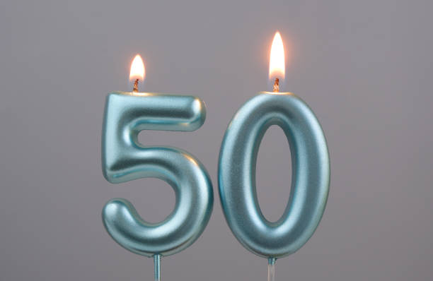 istock Blue birthday candles on gray background, number 50 2166889280