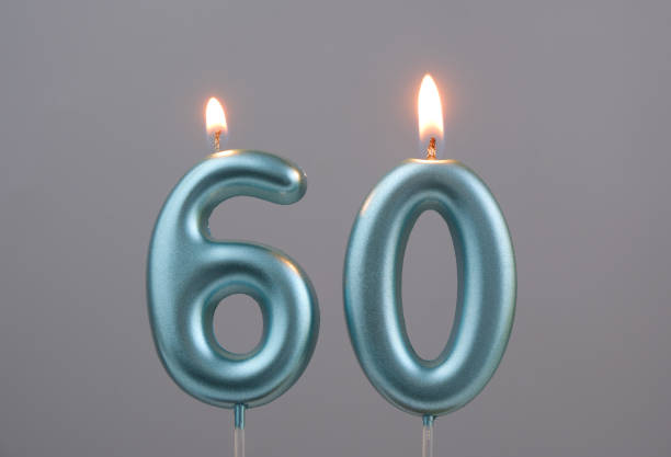 istock Blue birthday candles on gray background, number 60 2166889309