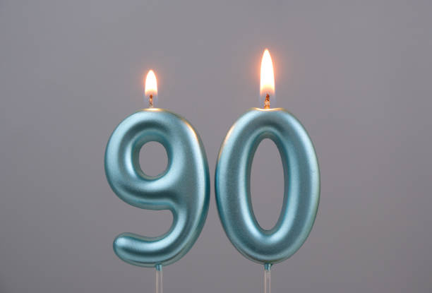 istock Blue birthday candles on gray background, number 90 2166889318