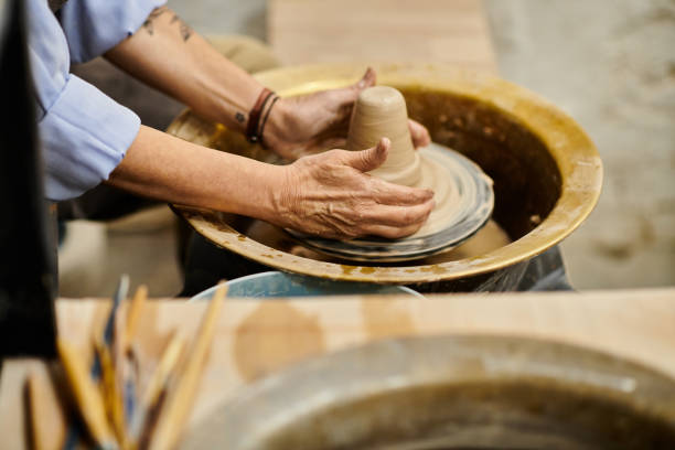 istock woman crafting earthenware at pottery workshop 2166889428