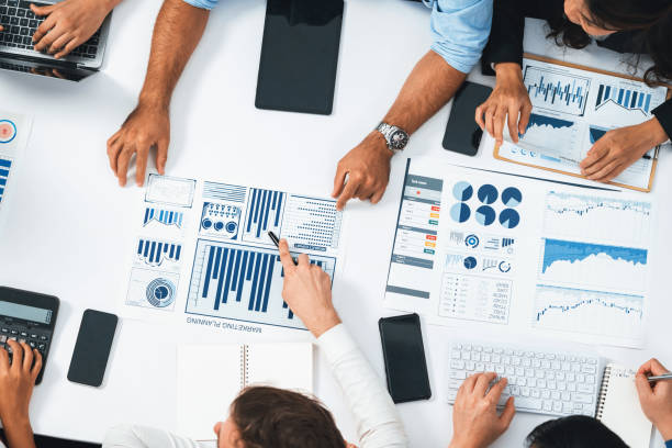 istock Analyst team utilizing BI Fintech to analyze financial data at table. Prudent 2166889761