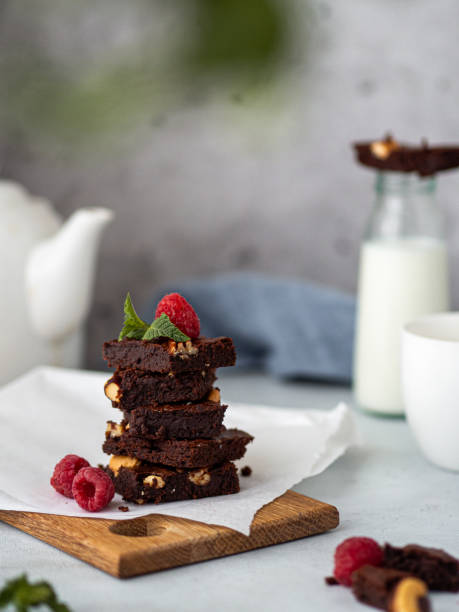 istock Chocolate Brownie with Raspberry on Wooden Board on Light Concrete Table 2166891174