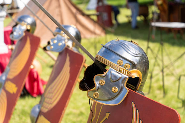 istock Ancient Roman legionary helmets on red legionary shields 2166892148
