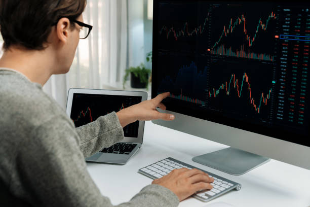 istock Investors pointing interesting stock exchange on pc with laptop. Pecuniary. 2166894148