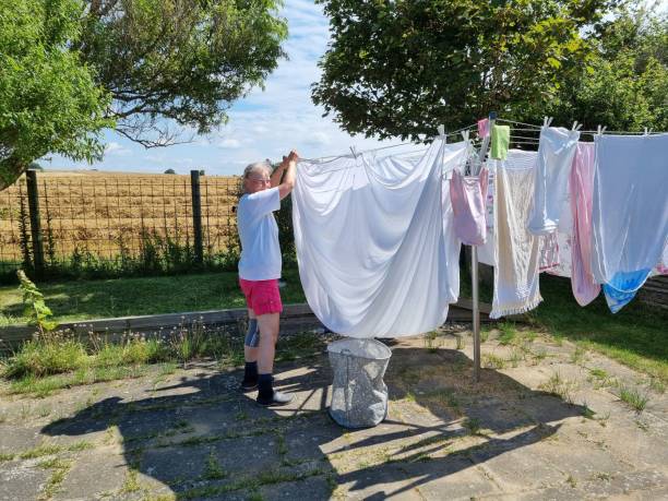 istock A female pensioner hangs laundry outside in the sunshine 2166896385