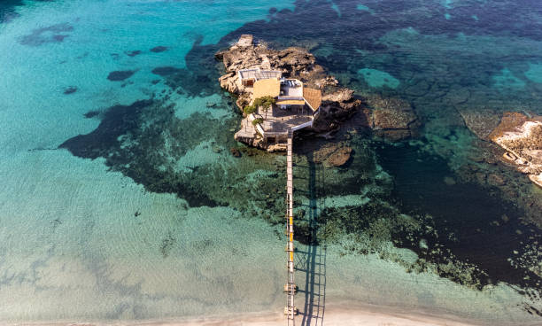 istock Wooden pier connecting small island with white sand beach in turquoise water. Majorca 2166896708