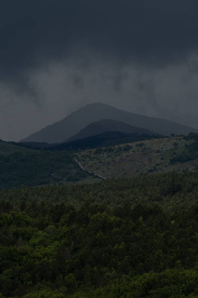 Dark storm clouds hang threateningly over the Croatian mountains.