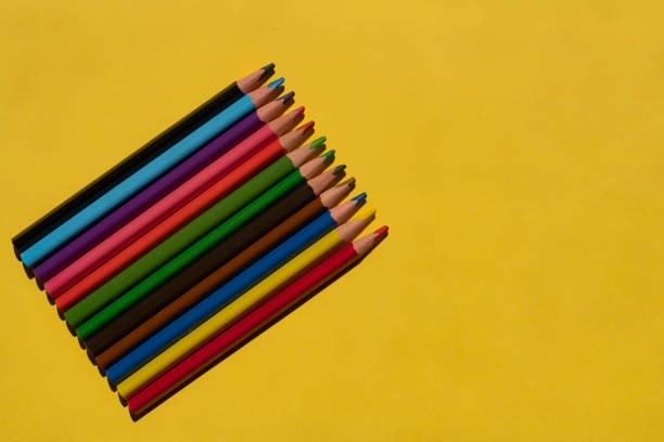 Colored pencils on the yellow background