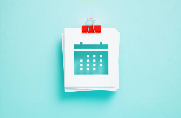 Cutout calendar symbol on post it notes on blue background. Horizontal composition. Reminder and calendar concept.