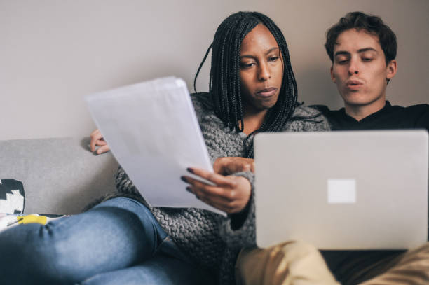 istock Young couple working at home in evening 2166899859