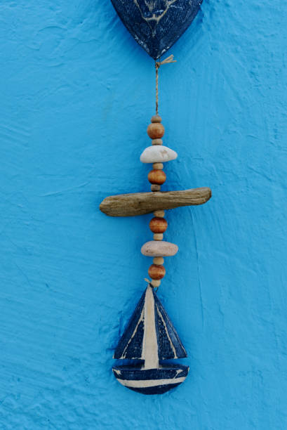 Coastal themed decoration hanging on a blue wall - vertical