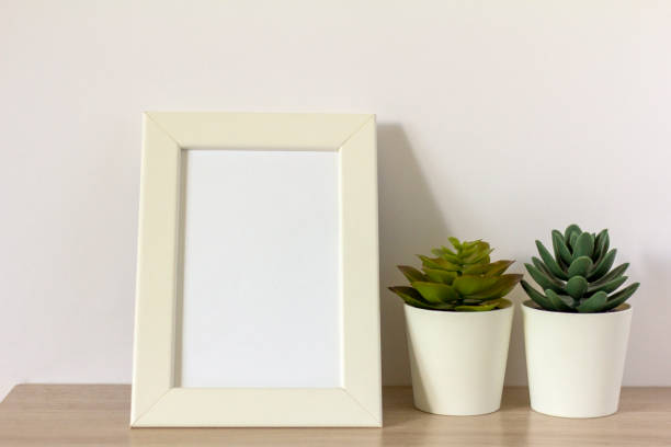 istock An empty photo frame on a table or shelf with a copy of the space. 2166903725