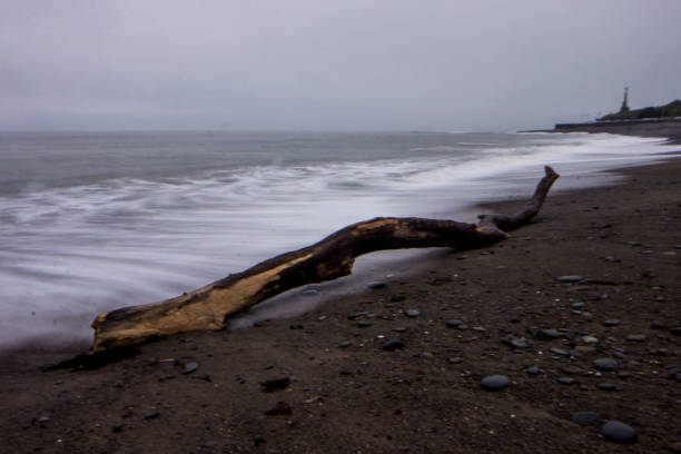 Long exposure at twilight with waves breaking on the shingles beach at Aberystwyth in Wales
