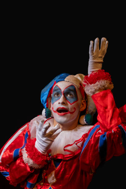 istock happy clown looking up on black background 2166905073