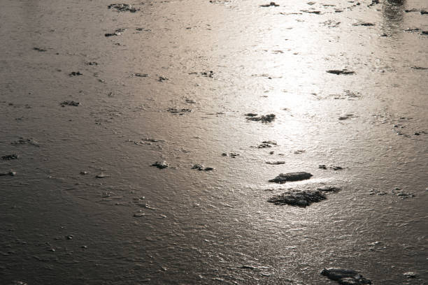 istock Sun reflecting on frozen water.. 2166911346