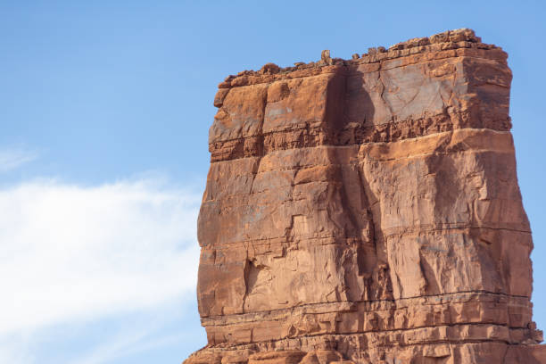istock The side of a towering red rock formation with blue sky and copy space. 2166912657