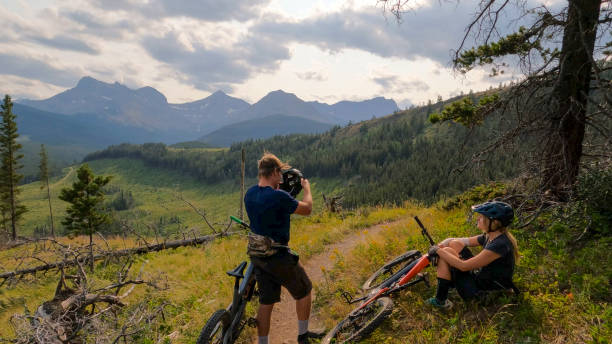 istock Mountain bikers relax on lush mountain trail 2166915352