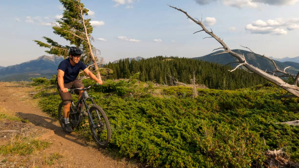 istock Mountain biker rides high mountain pathway 2166915386