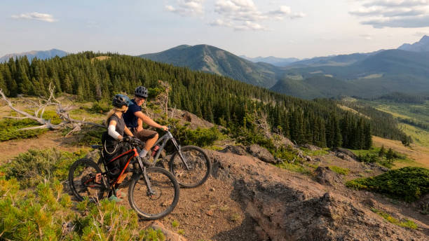 istock Mountain bikers ride lush mountain environment 2166915400