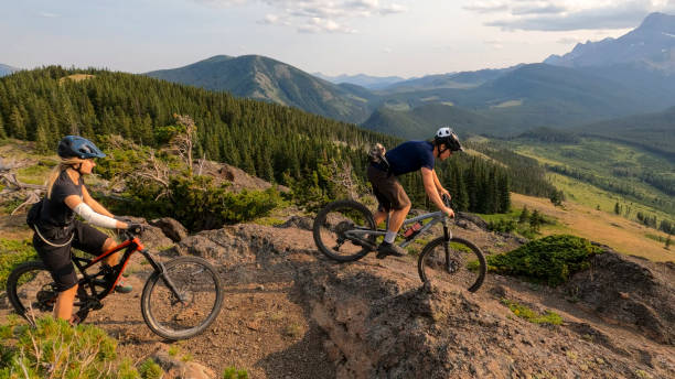 istock Mountain bikers ride lush mountain environment 2166915409