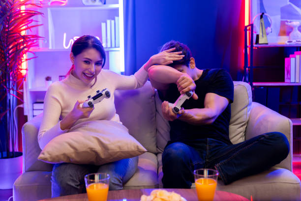 istock Couple joyful funny playing game using joysticks trying to disturb. Postulate. 2166918850