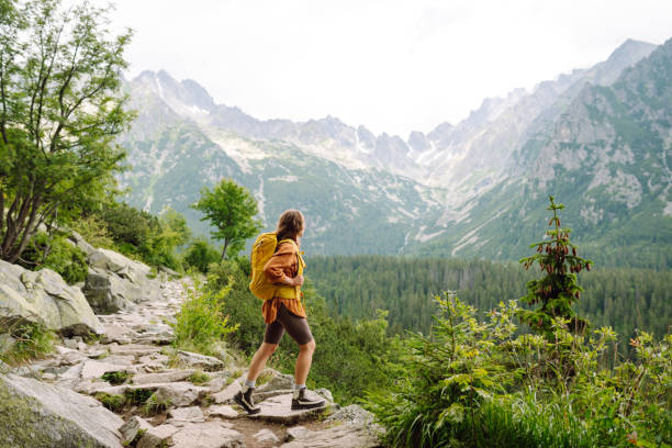 istock Smiling female with backpack on hike in nature. 2166921221