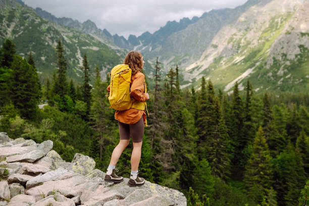 istock Smiling female with backpack on hike in nature. 2166921291