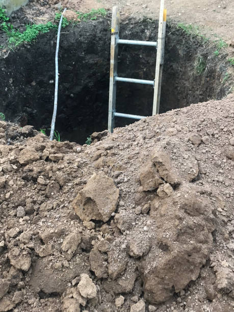 istock construction of a deep well with a ladder to go down. Building site 2166921562