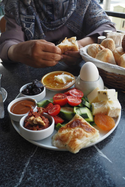 istock woman enjoying Turkish Breakfast Served at cafe 2166923094