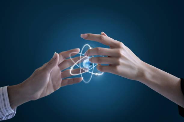 Atom structure model in a hand with nucleus and electrons, technological concept of nuclear power. Flat illustration on green background
